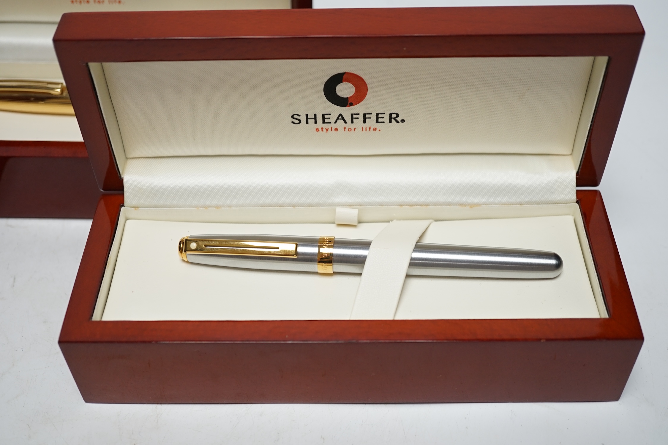 Three modern boxed Sheaffer fountain pens; an Imperial style pen and two others, all in stained beech cases